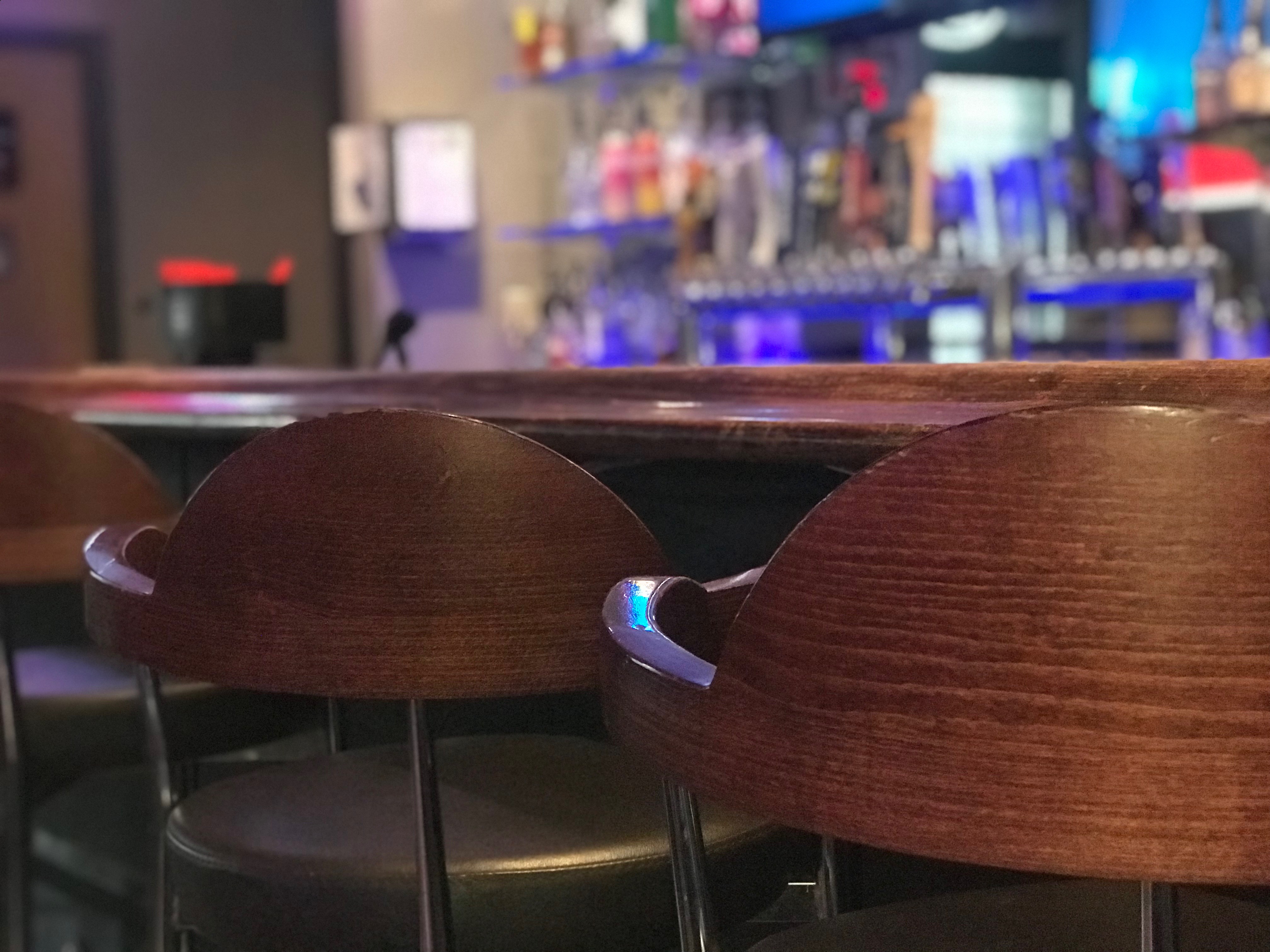 Three stools at a bar